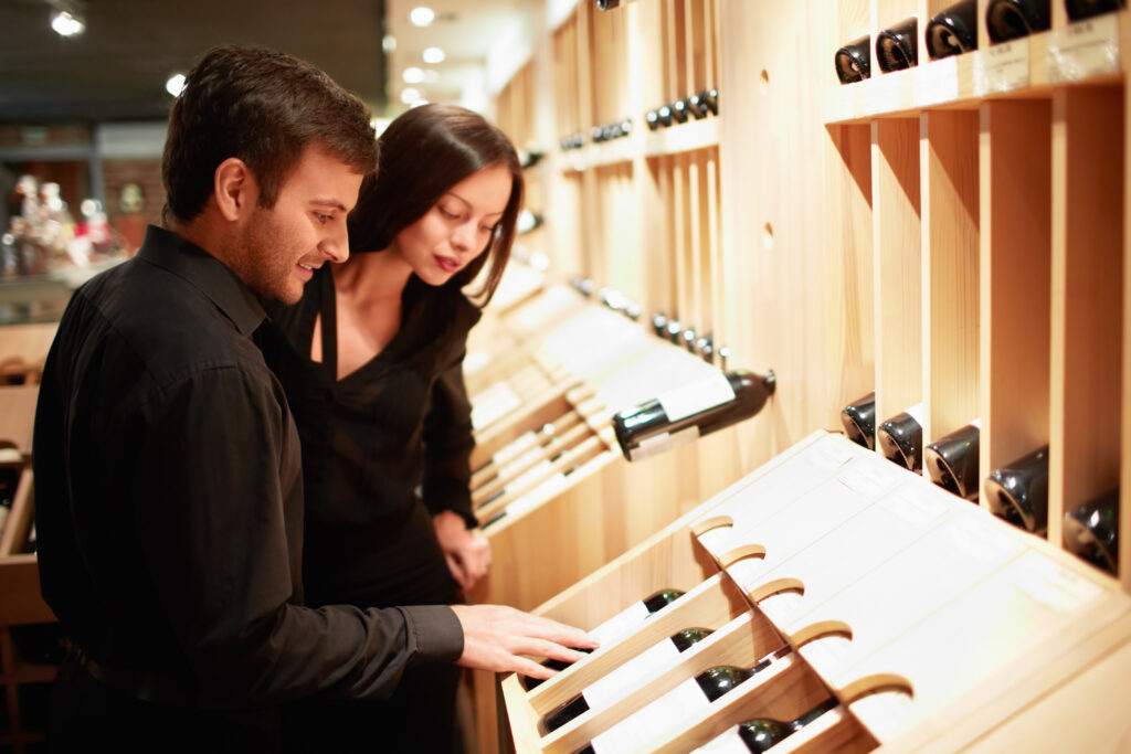 Young couple choosing wine in a store